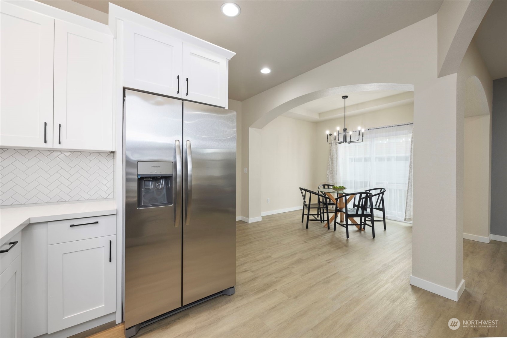 320 Graham Avenue Northeast Renton, WA 98059 - Photo 13 of 26 a kitchen with a refrigerator and table chair