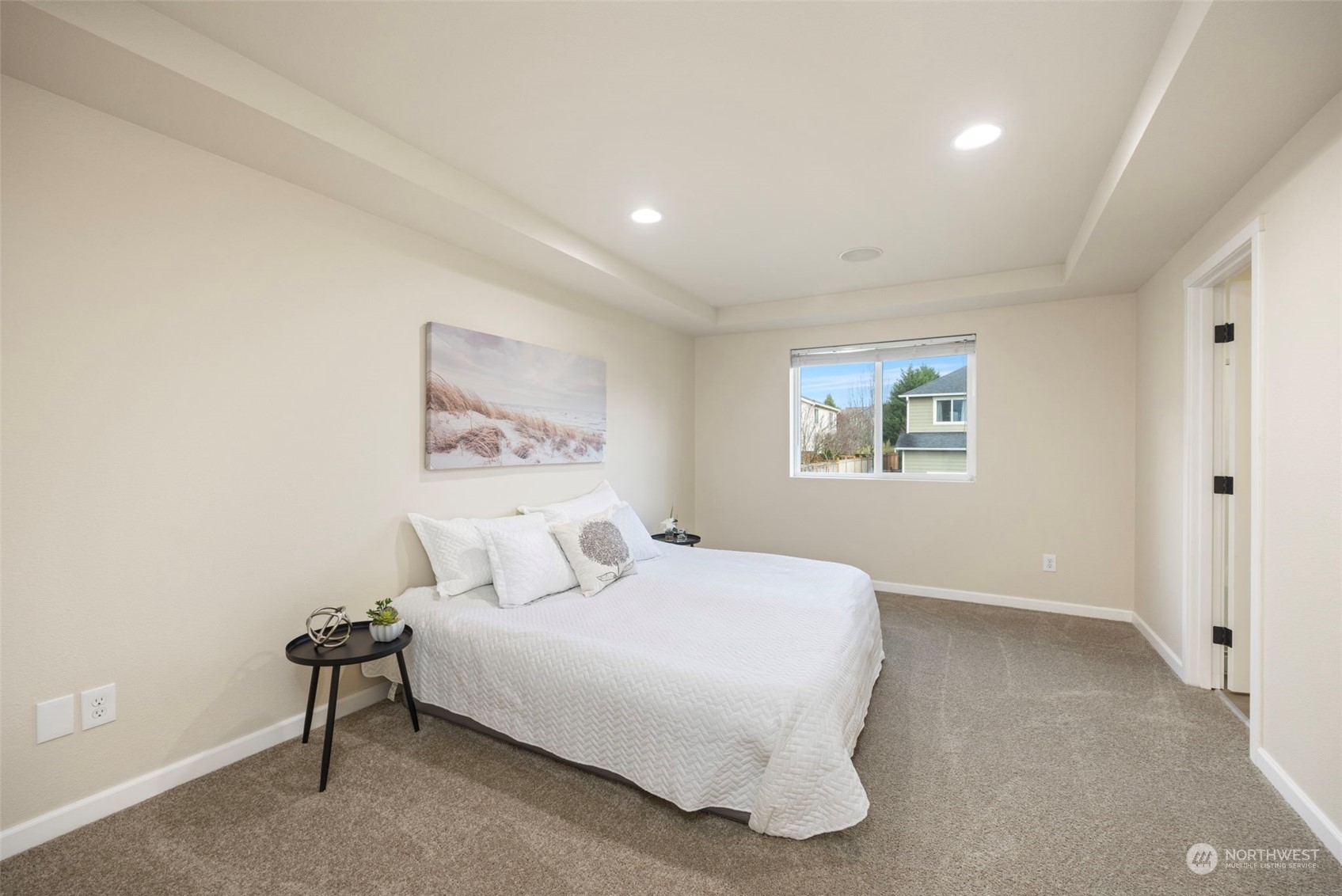 320 Graham Avenue Northeast Renton, WA 98059 - Photo 14 of 26 a bedroom with a large bed and a painting on the wall