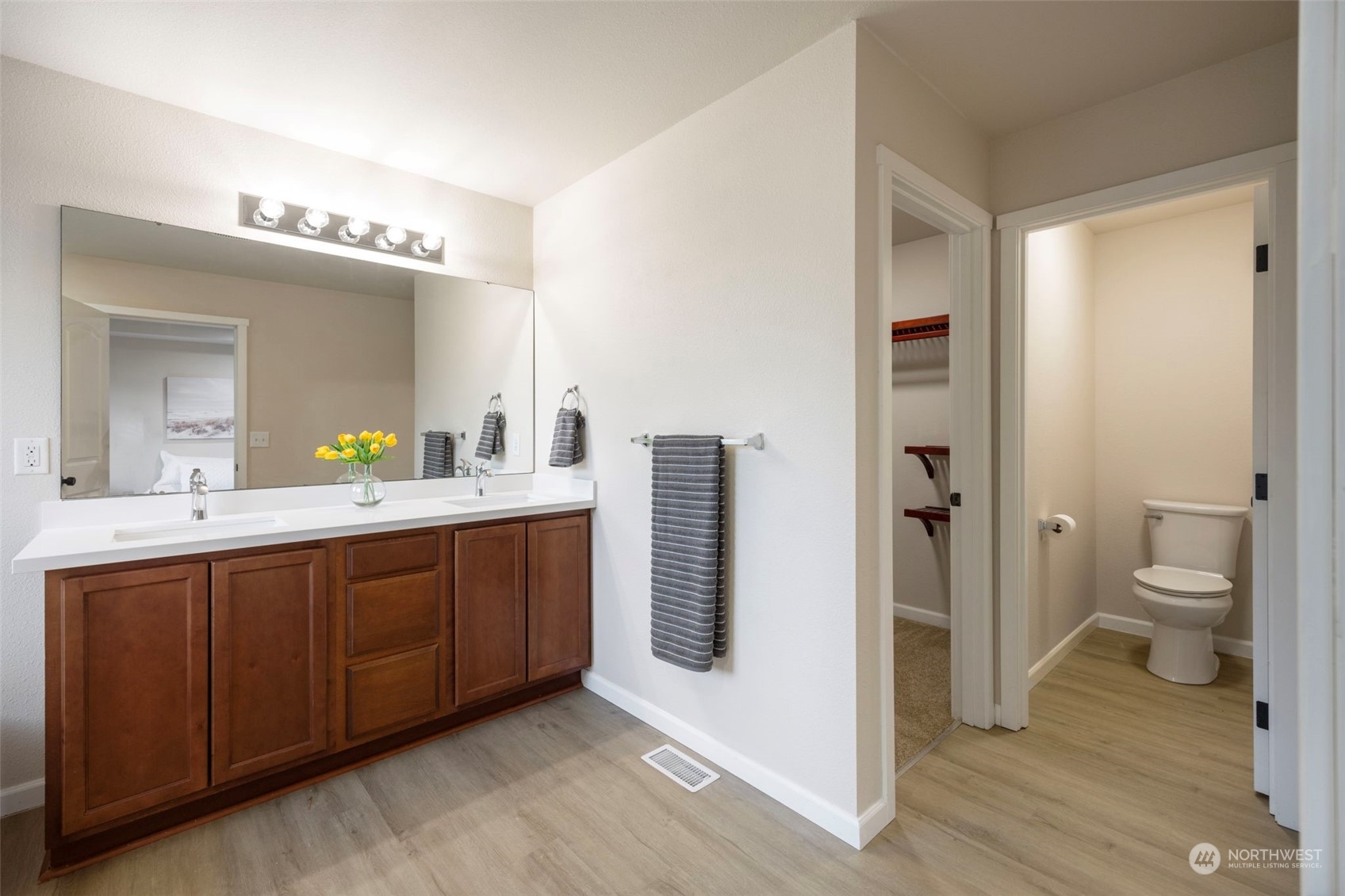 320 Graham Avenue Northeast Renton, WA 98059 - Photo 15 of 26 a spacious bathroom with a double vanity sink a toilet and a mirror