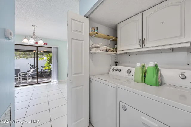 a kitchen with white cabinets and sink