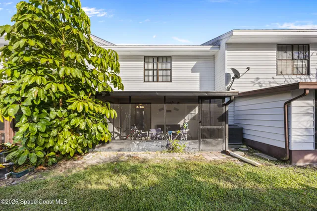 a backyard of a house with table and chairs
