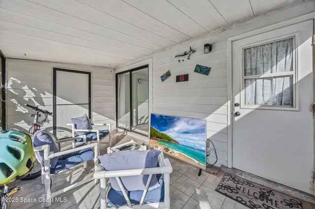a balcony with chairs and iron fence