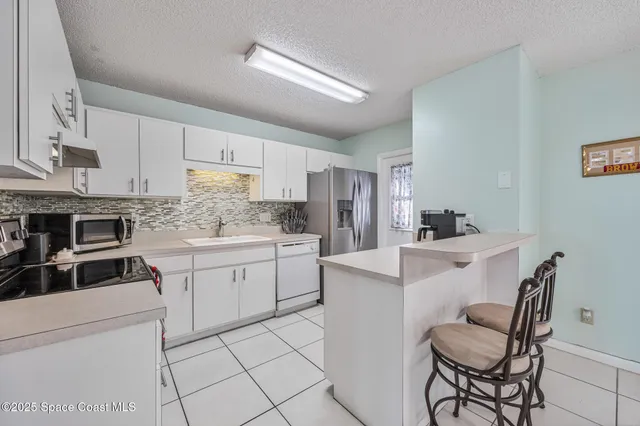 a kitchen with cabinets appliances and a center island