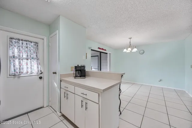 a view of a kitchen with a sink dishwasher and wooden floor
