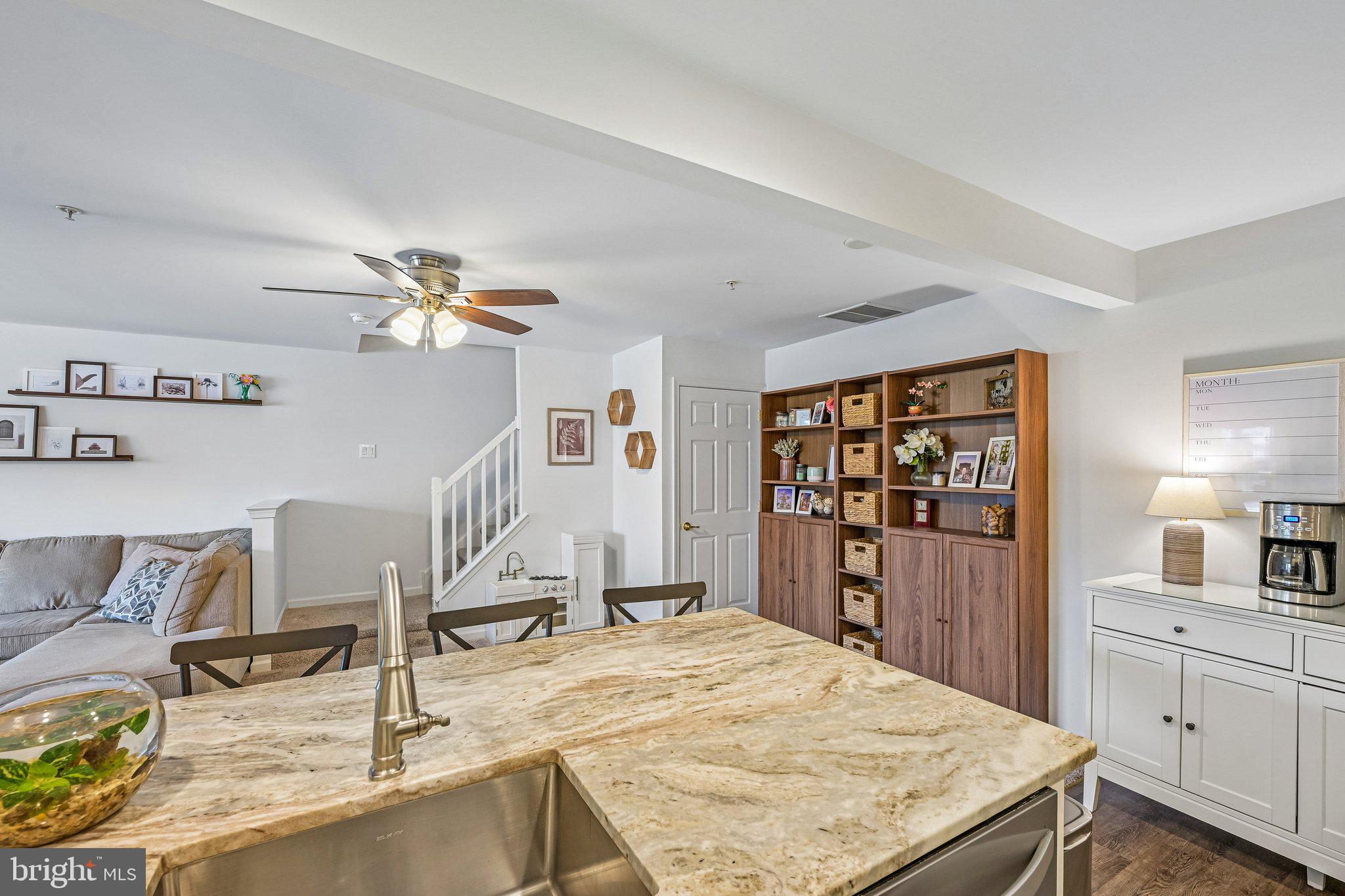 203 Flagstone Road, Unit 6 Chester Springs, PA 19425 - Photo 9 of 17 a living room with kitchen island furniture and a kitchen view