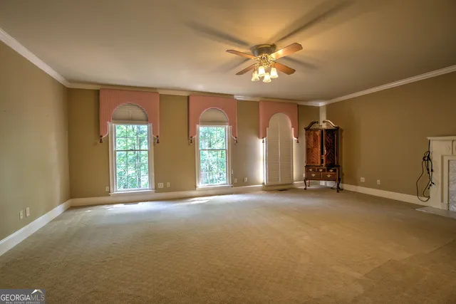 a room with pool table and windows