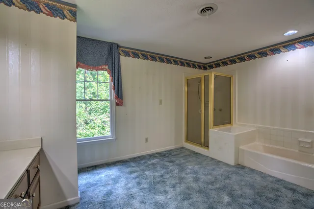 a bathroom with a sink a toilet a mirror and shower