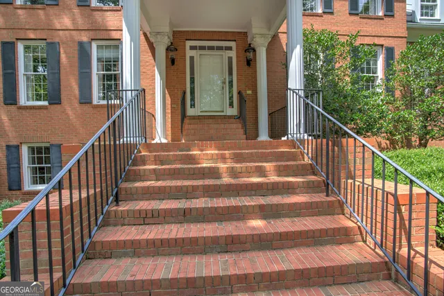 a view of a hallway with entryway wooden floor and front door