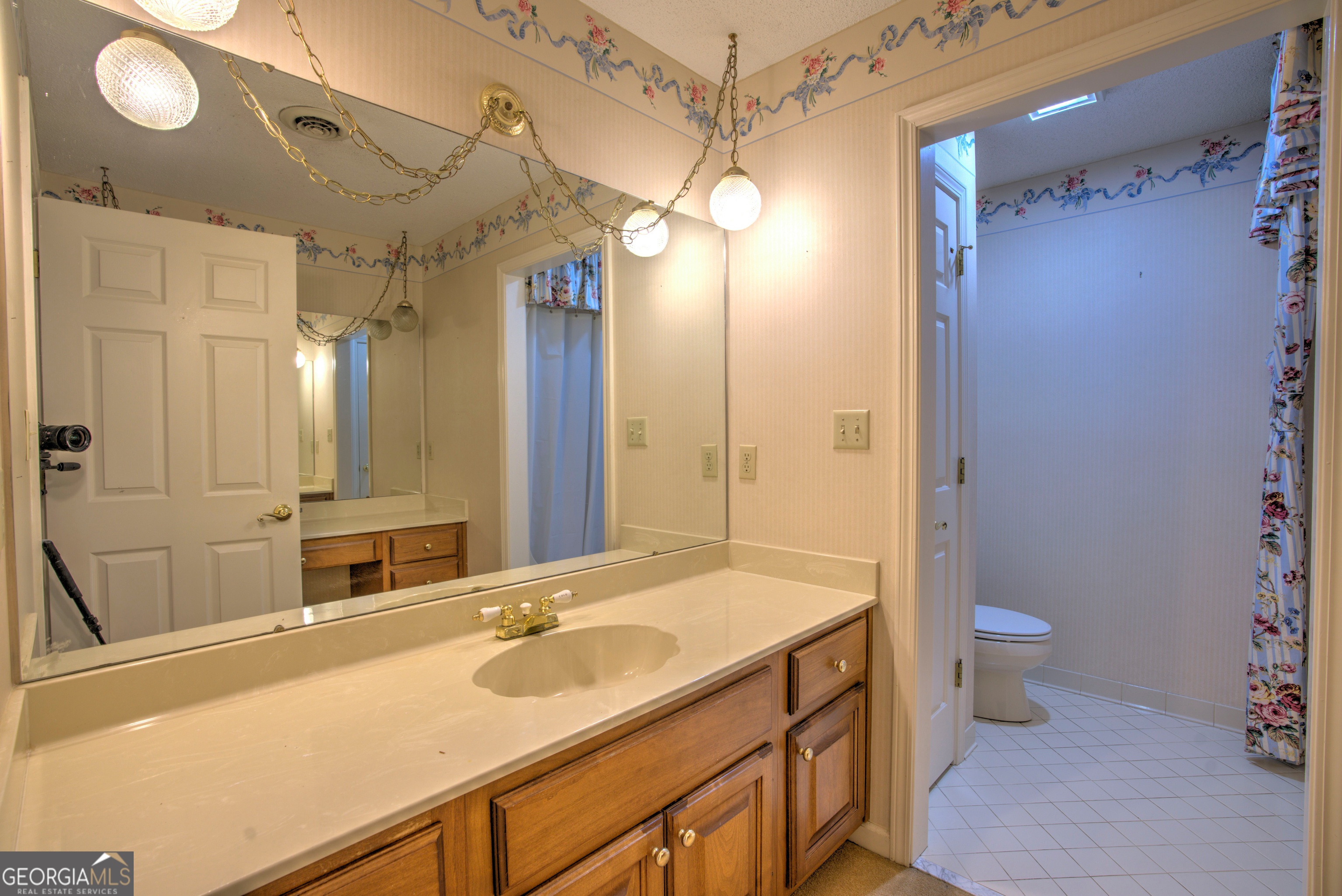 15 Ladonna Place Southwest Rome, GA 30165 - Photo 37 of 70 a bathroom with a sink a toilet a mirror and shower