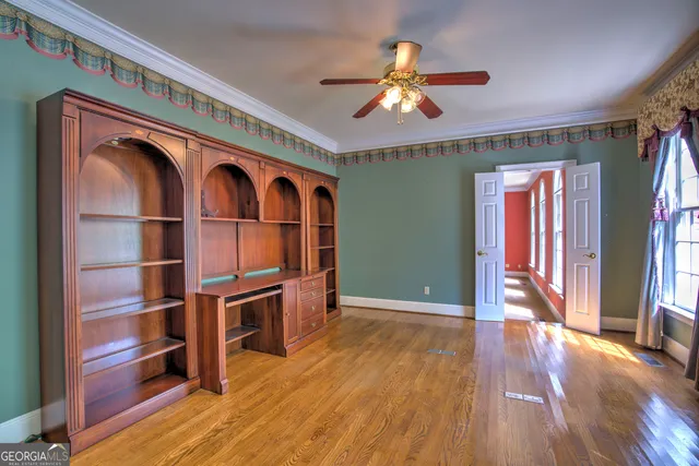 a view of livingroom with furniture fan window and wooden floor