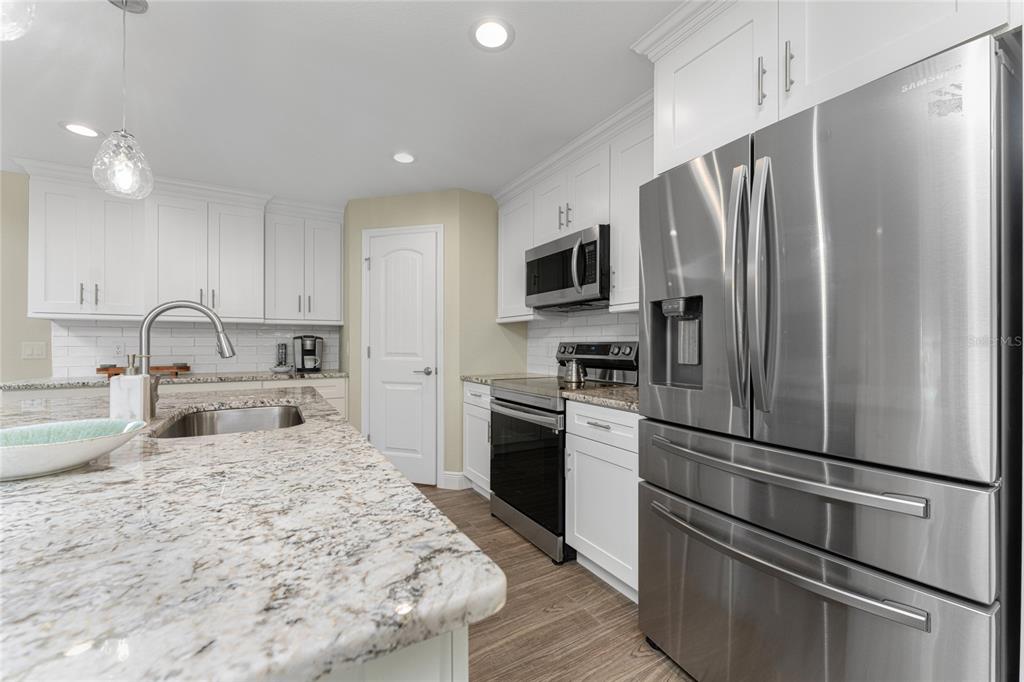 184 Spring Drive Rotonda West, FL 33947 - Photo 18 of 54 a kitchen with stainless steel appliances a refrigerator sink and microwave
