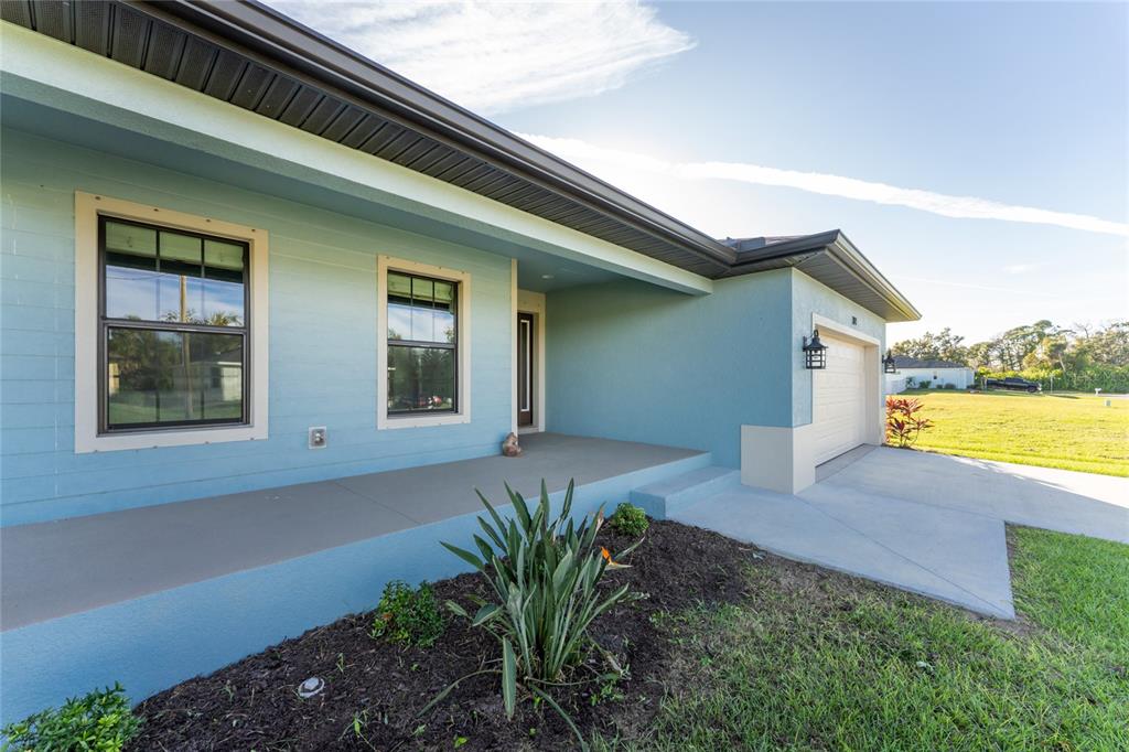 184 Spring Drive Rotonda West, FL 33947 - Photo 2 of 54 a house with garden in front of it