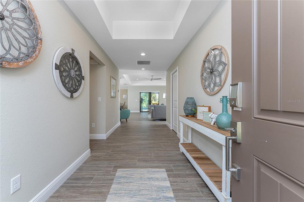 184 Spring Drive Rotonda West, FL 33947 - Photo 21 of 54 a view of a hallway with wooden floor