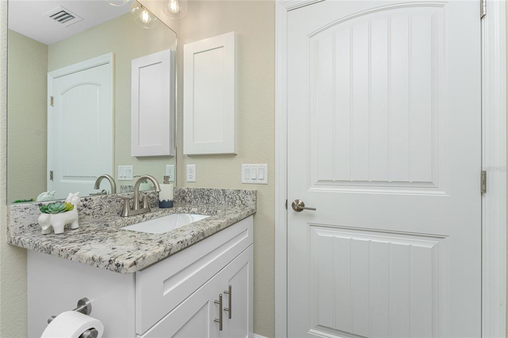 184 Spring Drive Rotonda West, FL 33947 - Photo 27 of 54 a bathroom with a granite countertop sink and a mirror
