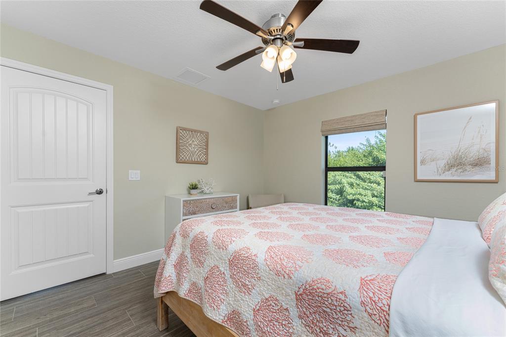 184 Spring Drive Rotonda West, FL 33947 - Photo 29 of 54 a bedroom with a large bed and a window