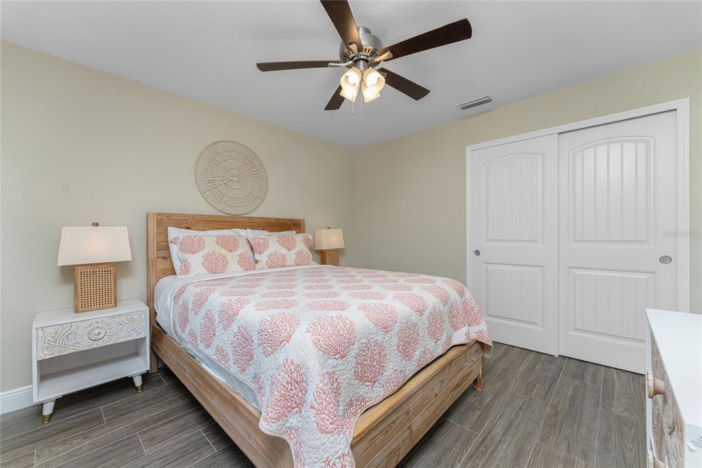 184 Spring Drive Rotonda West, FL 33947 - Photo 30 of 54 a bedroom with a bed and a chandelier