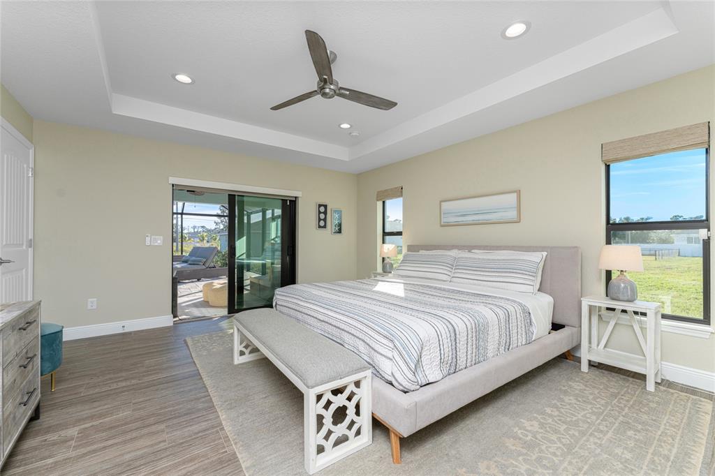184 Spring Drive Rotonda West, FL 33947 - Photo 33 of 54 a spacious bedroom with a bed and painting on the wall