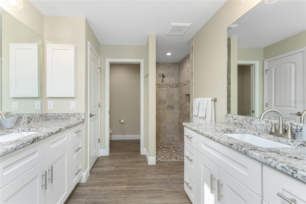 184 Spring Drive Rotonda West, FL 33947 - Photo 35 of 54 a bathroom with a granite countertop double vanity sink and mirror