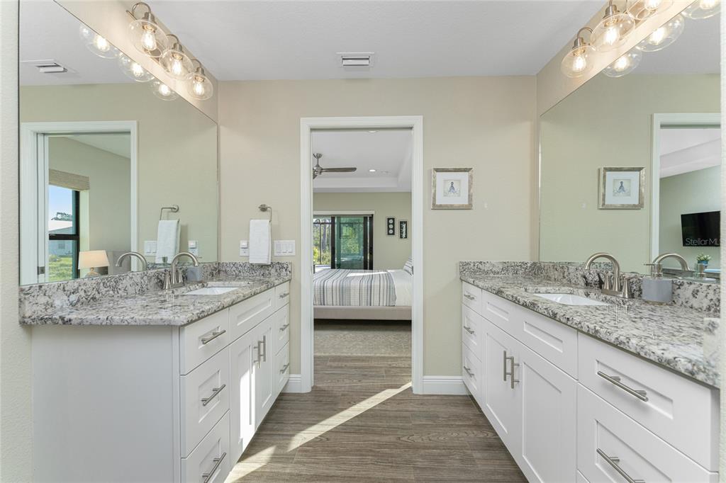 184 Spring Drive Rotonda West, FL 33947 - Photo 37 of 54 a bathroom with a granite countertop double vanity sink and a mirror