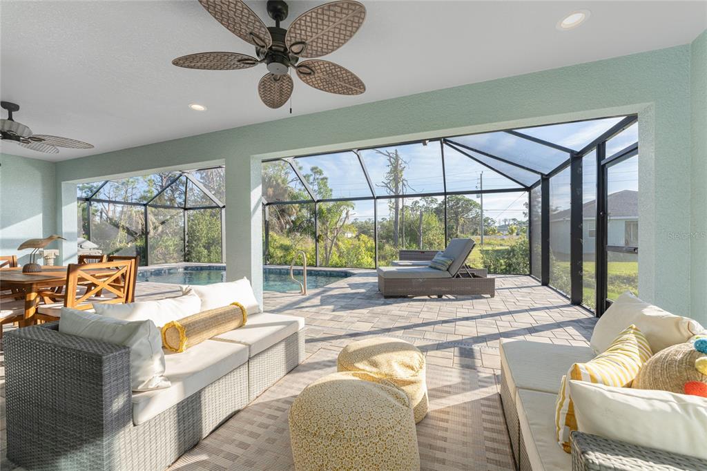 184 Spring Drive Rotonda West, FL 33947 - Photo 41 of 54 a living room with patio furniture and a large window