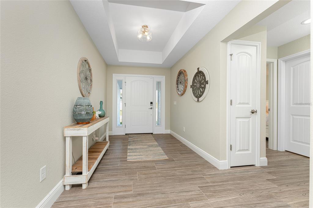 184 Spring Drive Rotonda West, FL 33947 - Photo 5 of 54 a view of a hallway with wooden floor and a hallway