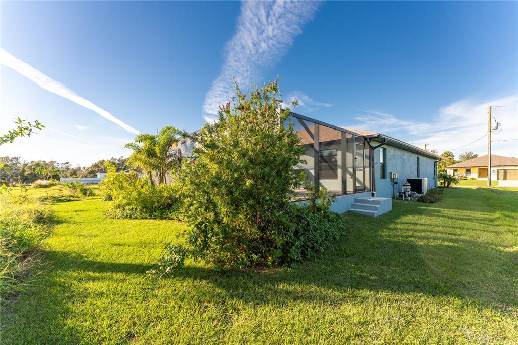 184 Spring Drive Rotonda West, FL 33947 - Photo 51 of 54 a view of a garden with an outdoor space