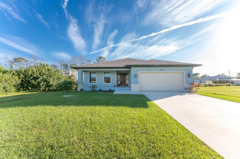 184 Spring Drive Rotonda West, FL 33947 - Photo 54 of 54 a front view of a house with garden