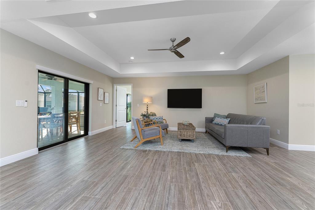 184 Spring Drive Rotonda West, FL 33947 - Photo 8 of 54 a living room with furniture and a flat screen tv