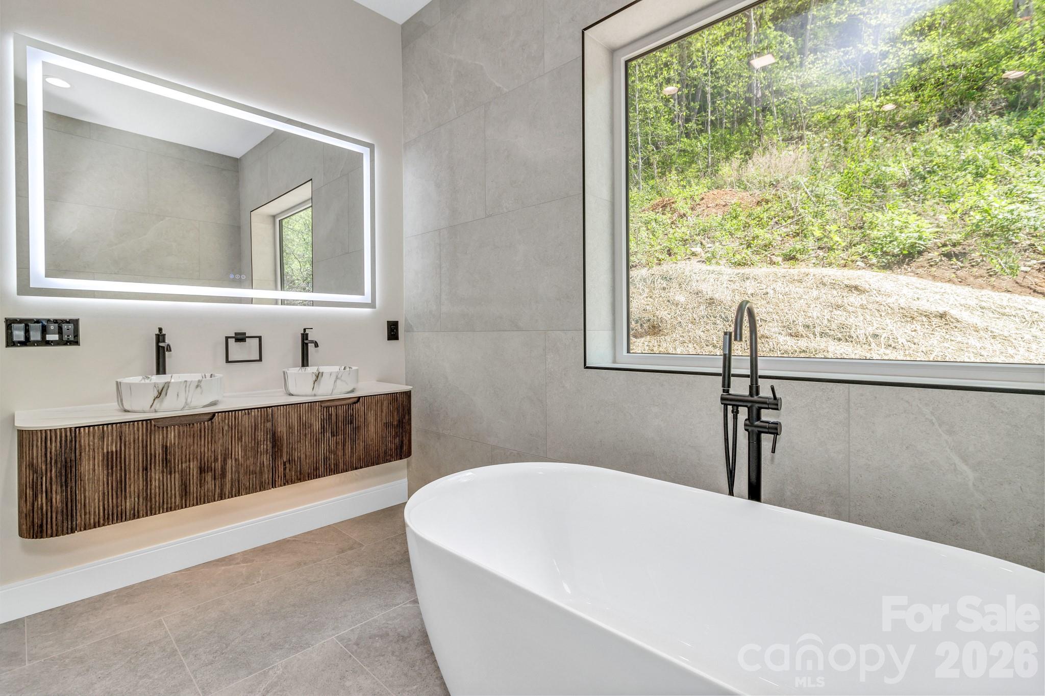 134 View Ridge Parkway Leicester, NC 28748 - Photo 29 of 48 a bathroom with a bathtub and a sink