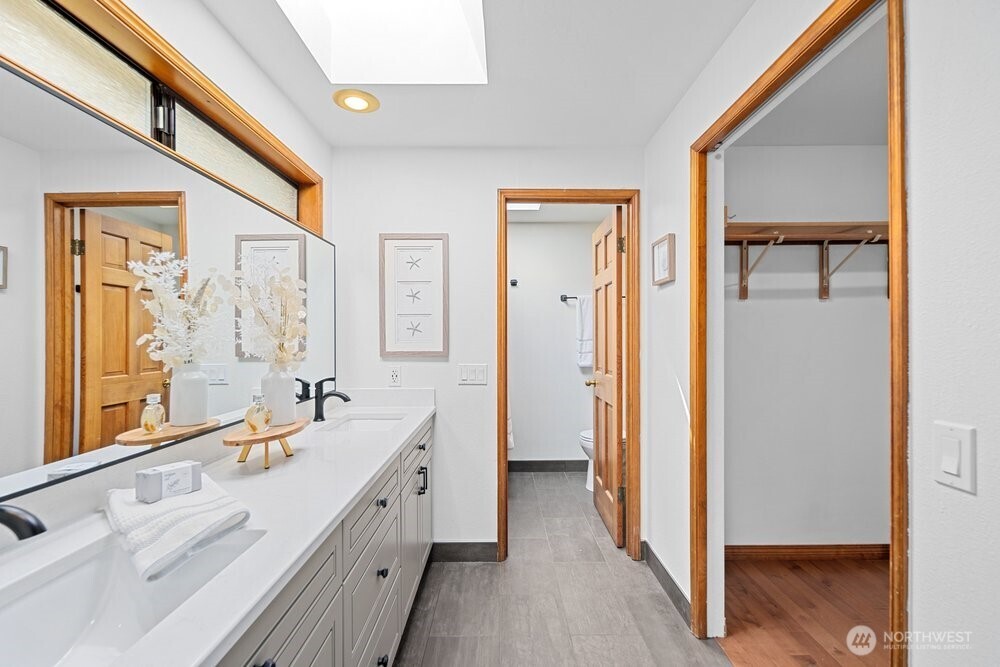 902 7th Avenue South Edmonds, WA 98020 - Photo 17 of 31 a spacious bathroom with a double vanity sink a mirror and a bathtub