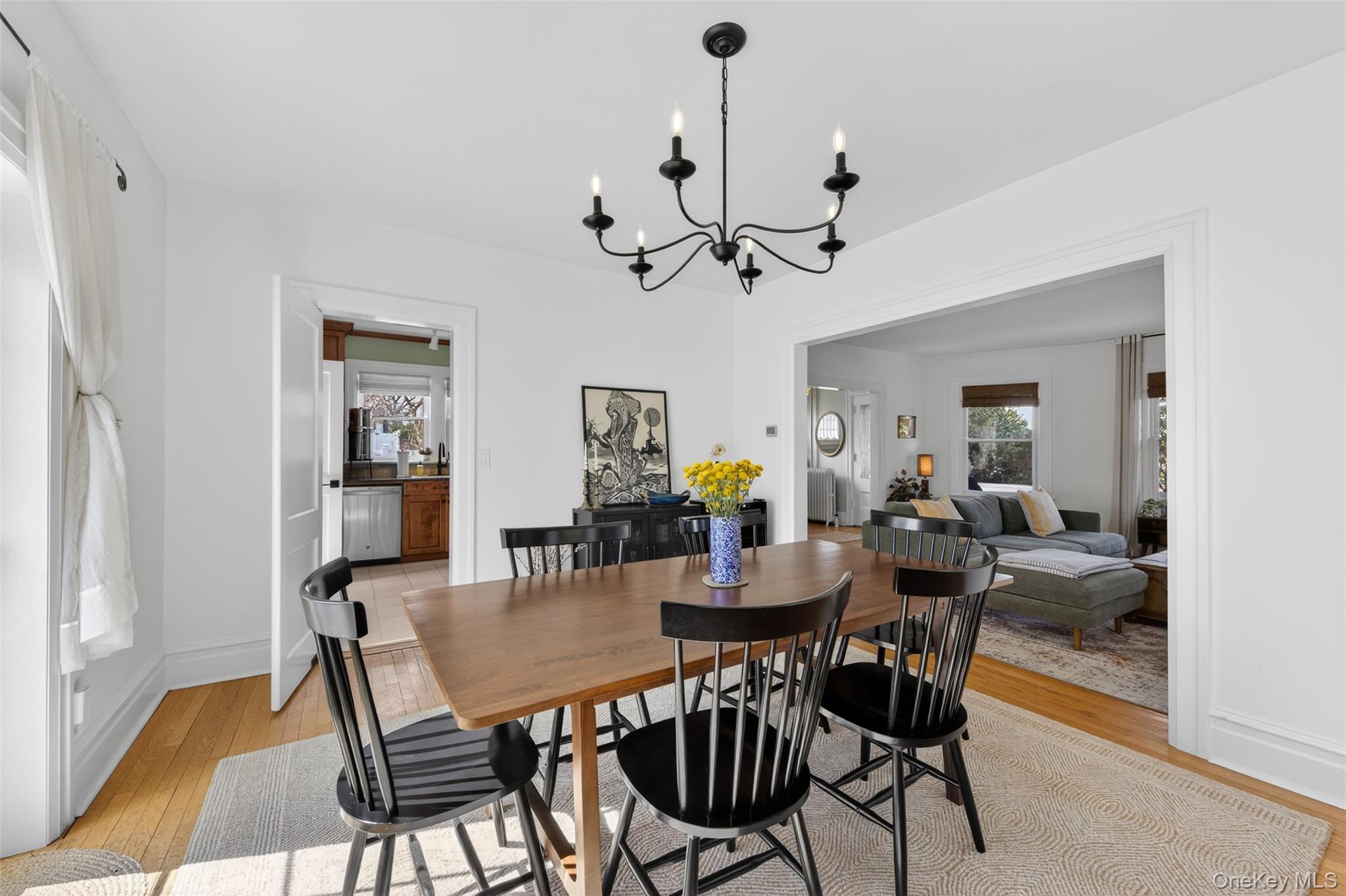 4 Spaulding Place Ossining, NY 10562 - Photo 13 of 43 a view of a dining room and livingroom with furniture wooden floor a chandelier