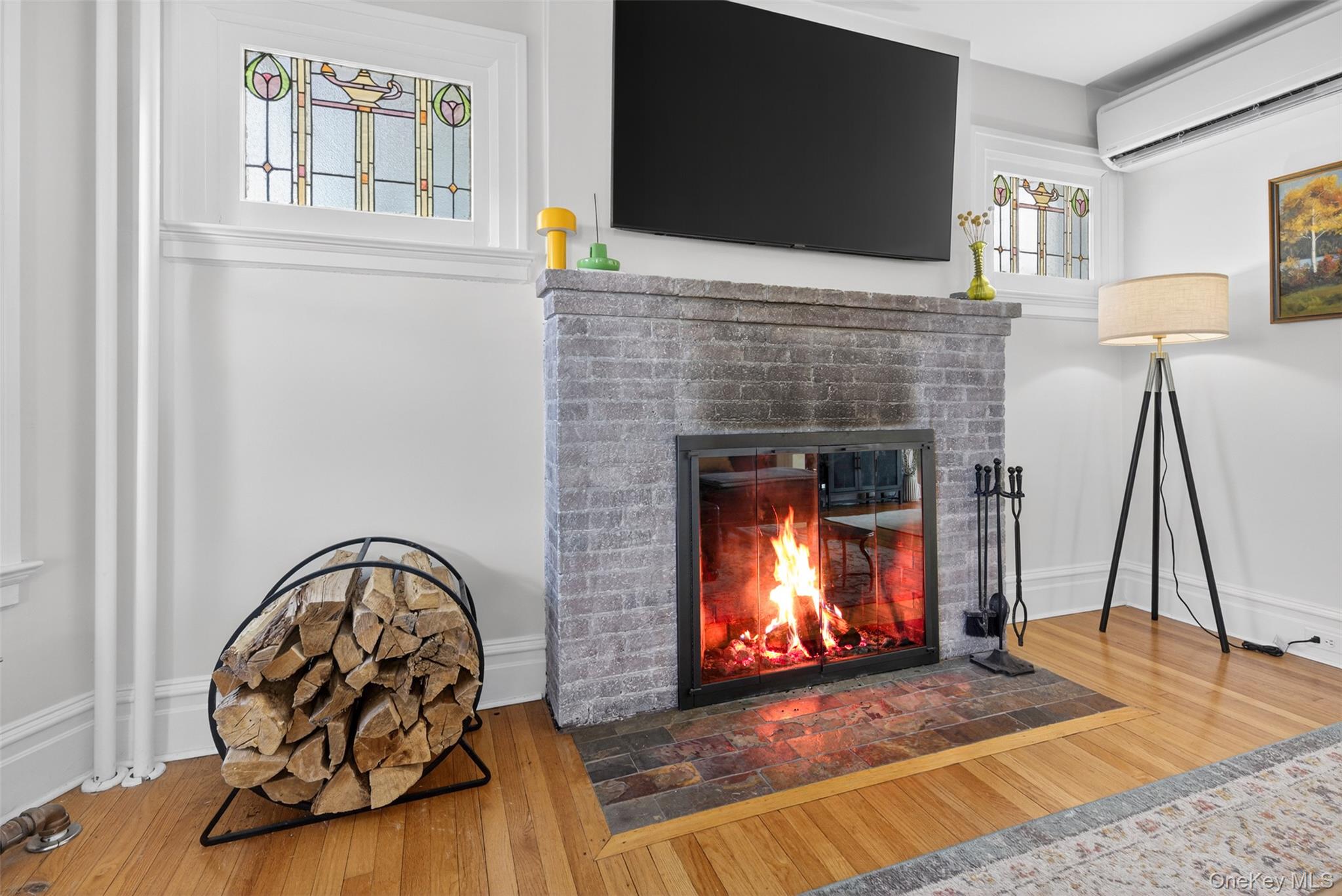 4 Spaulding Place Ossining, NY 10562 - Photo 10 of 43 a living room with a fireplace and a flat screen tv
