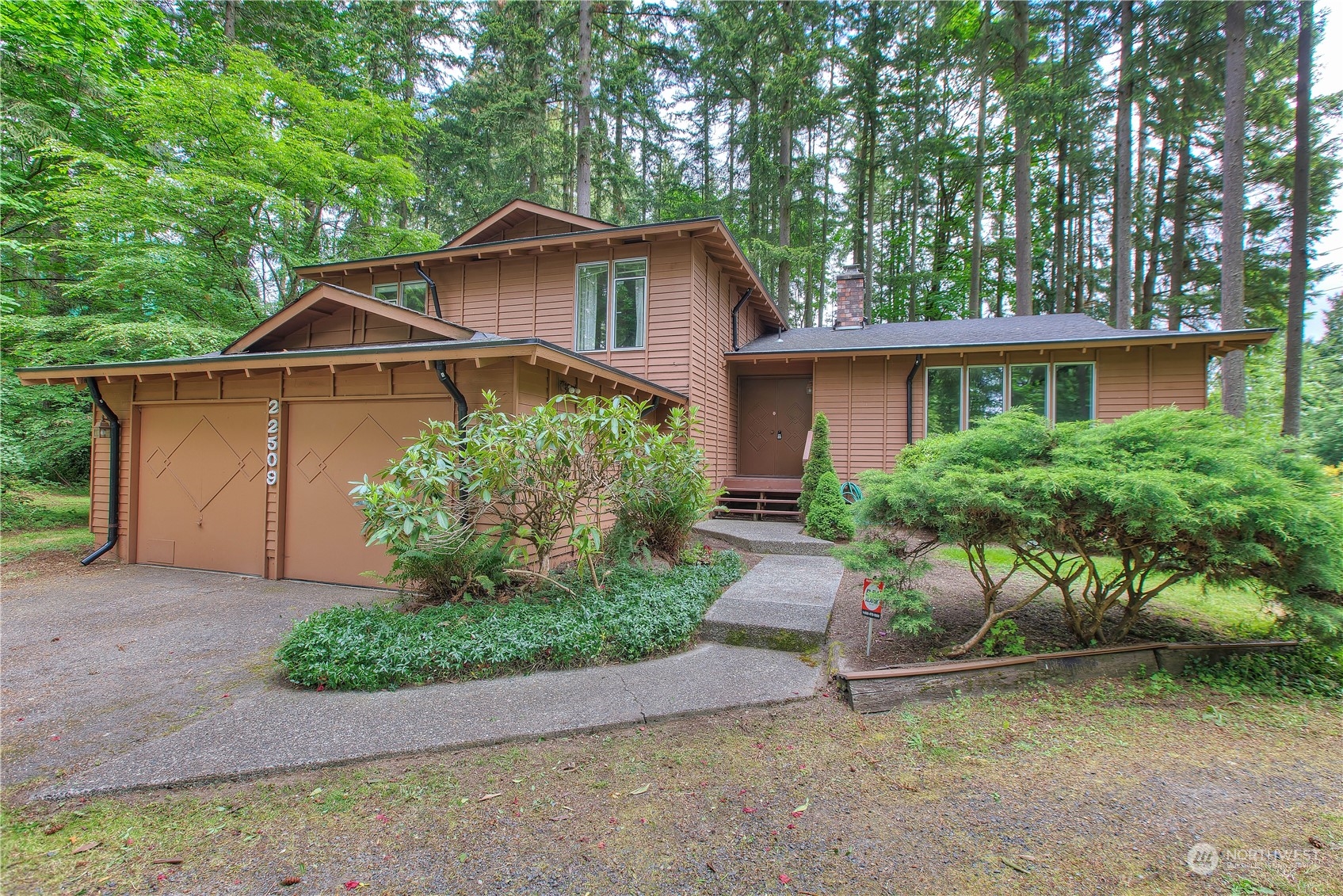 22509 45th Avenue Southeast Bothell, WA 98021 - Photo 1 of 31 a front view of a house with garden