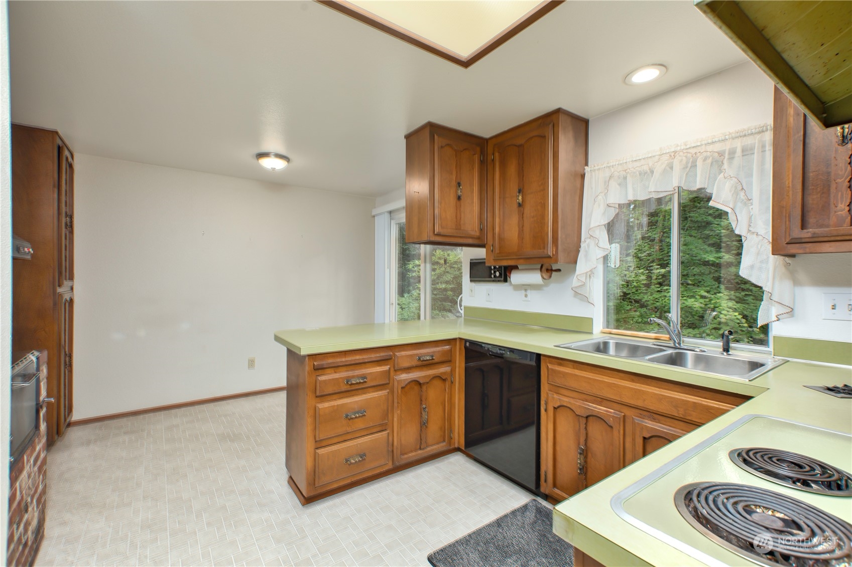 22509 45th Avenue Southeast Bothell, WA 98021 - Photo 11 of 31 a kitchen that has a sink and a stove in it