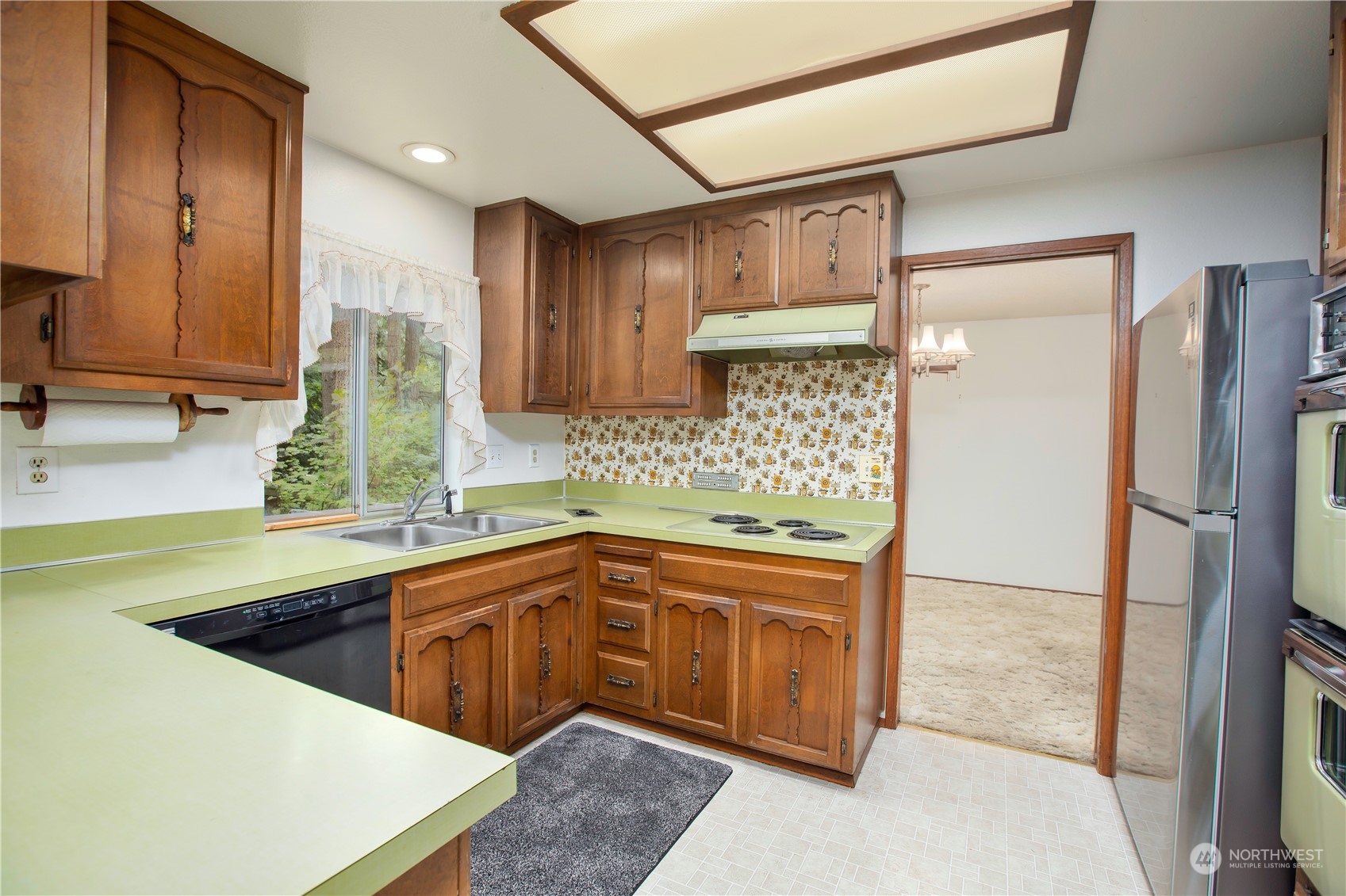 22509 45th Avenue Southeast Bothell, WA 98021 - Photo 9 of 31 a kitchen that has a sink and a refrigerator