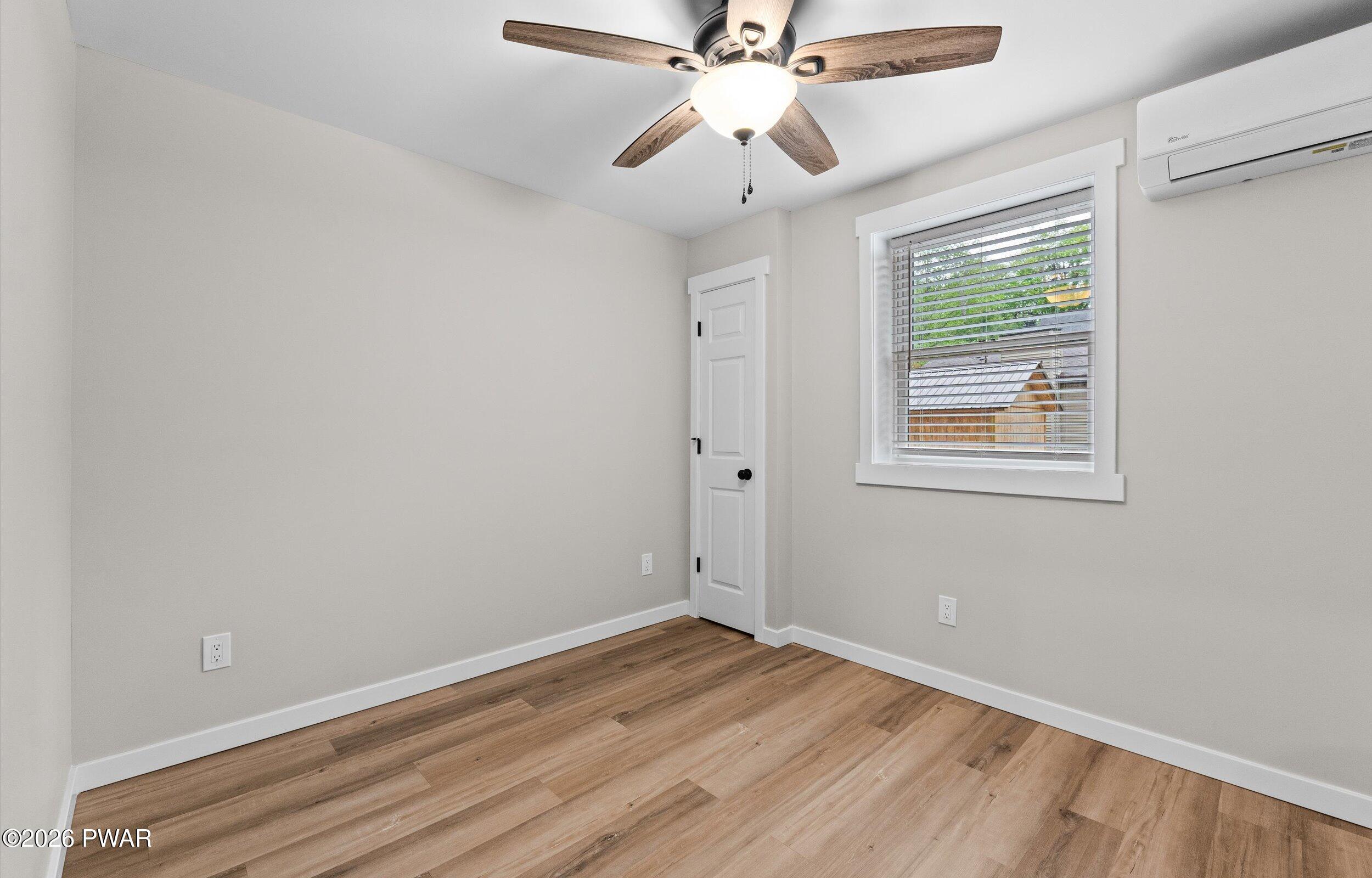 9 High Point Court Lake Ariel, PA 18436 - Photo 21 of 40 a view of an empty room with wooden floor and a window