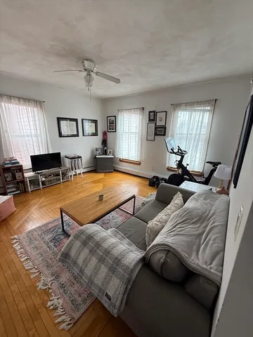 a living room with furniture rug and window