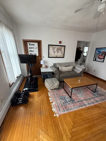 a living room with couch piano and a table