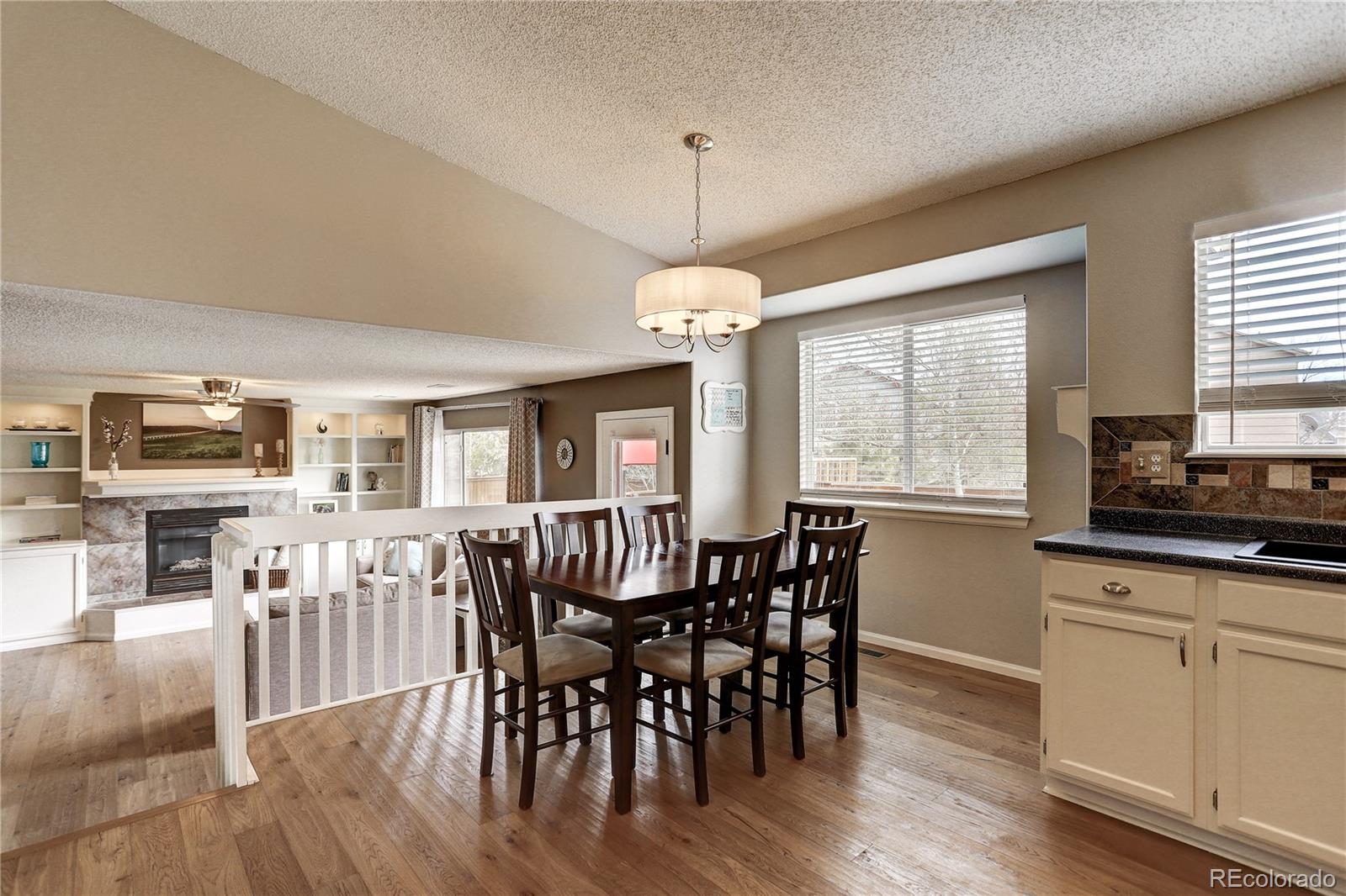 10626 Hyacinth Court Highlands Ranch, CO 80129 - Photo 13 of 38 a view of a dining room with furniture window and wooden floor
