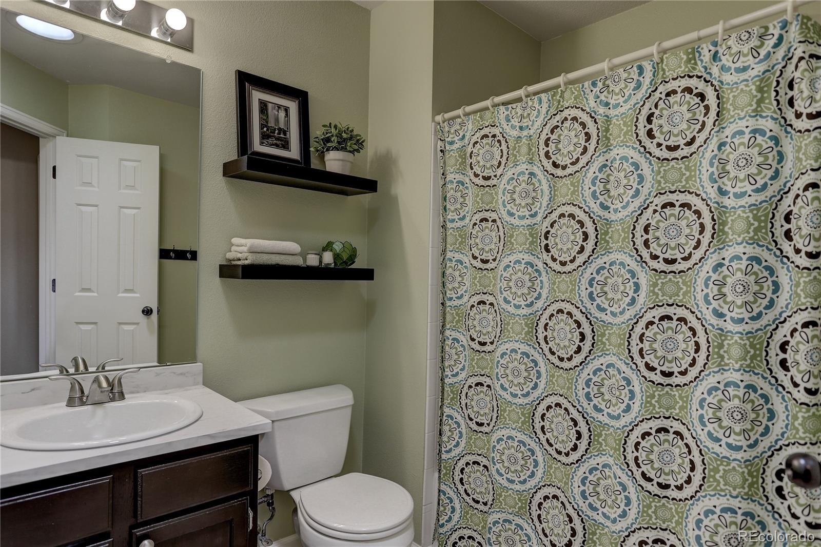 10626 Hyacinth Court Highlands Ranch, CO 80129 - Photo 18 of 38 a bathroom with a toilet and sink