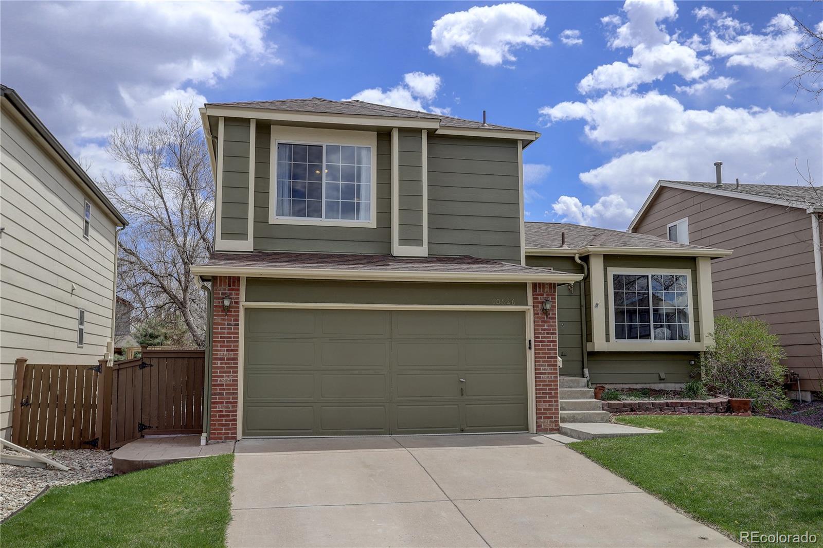10626 Hyacinth Court Highlands Ranch, CO 80129 - Photo 2 of 38 a front view of a house with garden