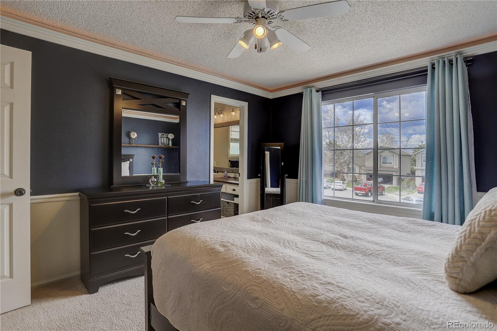 10626 Hyacinth Court Highlands Ranch, CO 80129 - Photo 23 of 38 a bedroom with a bed and a large mirror