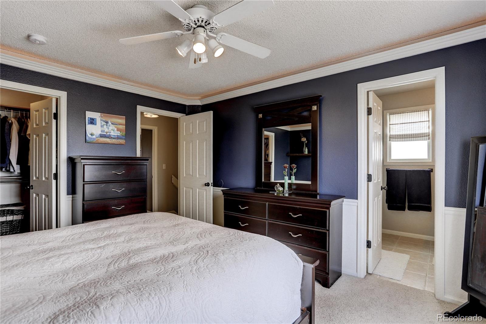 10626 Hyacinth Court Highlands Ranch, CO 80129 - Photo 26 of 38 a bedroom with a bed and a large mirror on the dresser