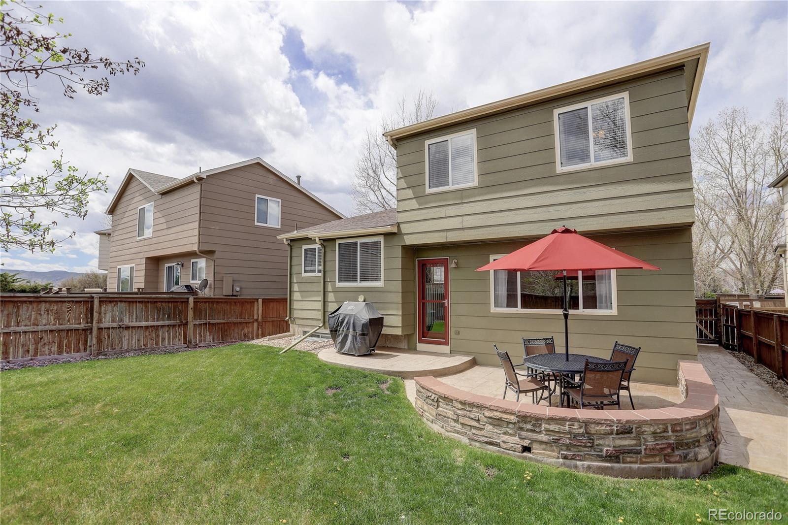 10626 Hyacinth Court Highlands Ranch, CO 80129 - Photo 38 of 38 a front view of house with yard and outdoor seating