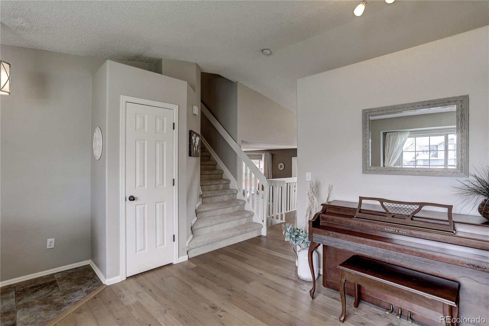 10626 Hyacinth Court Highlands Ranch, CO 80129 - Photo 4 of 38 a room with wooden floors and stairs