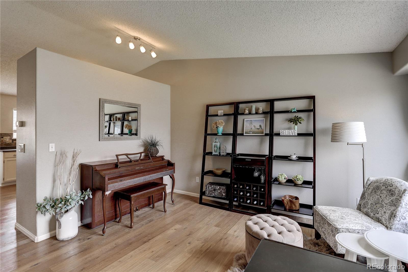 10626 Hyacinth Court Highlands Ranch, CO 80129 - Photo 5 of 38 a living room with furniture and a piano