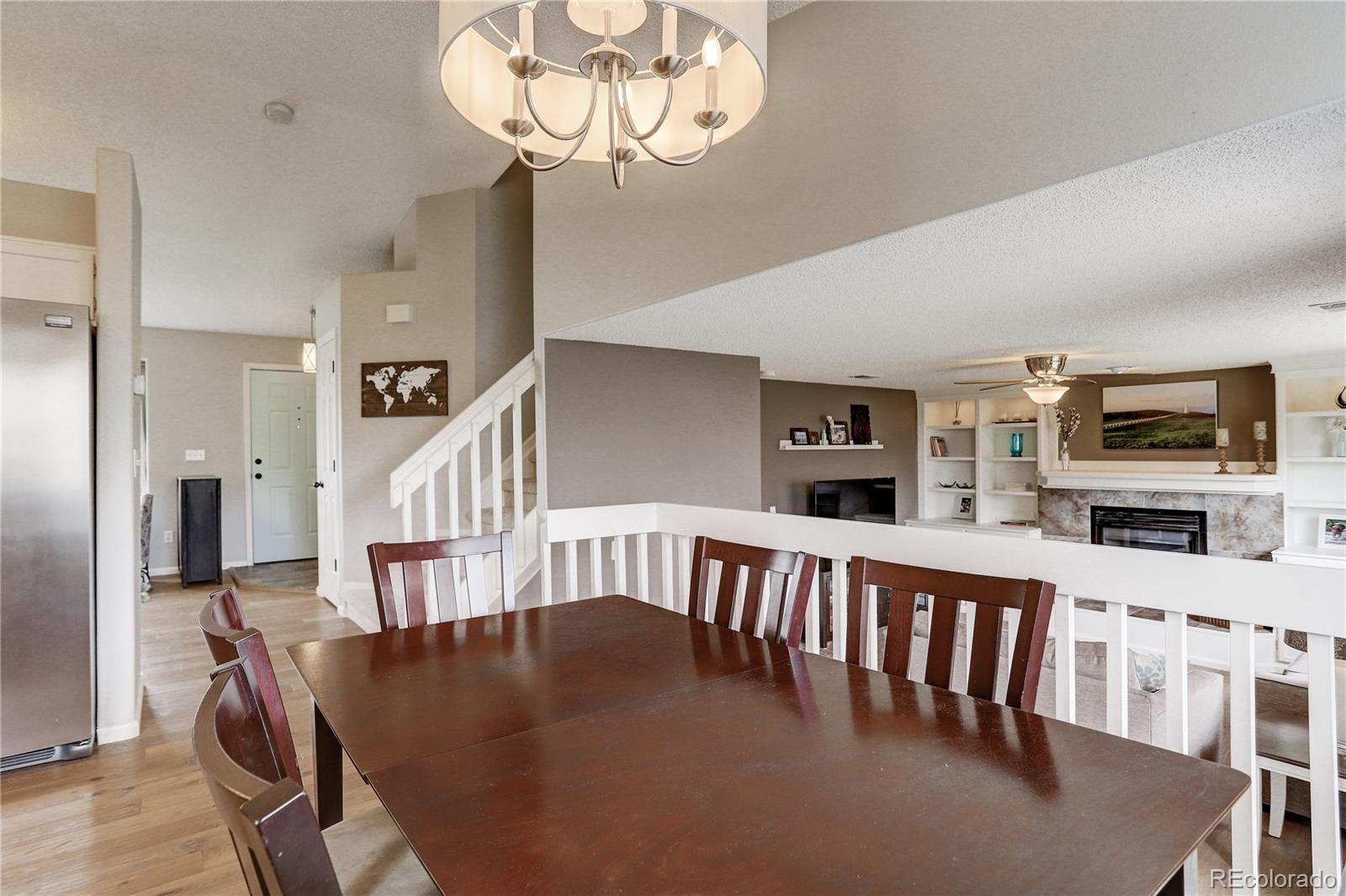 10626 Hyacinth Court Highlands Ranch, CO 80129 - Photo 6 of 38 a view of a dining room with furniture wooden floor and chandelier