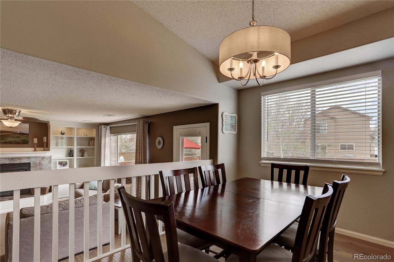 10626 Hyacinth Court Highlands Ranch, CO 80129 - Photo 7 of 38 a view of a dining room with furniture window and wooden floor