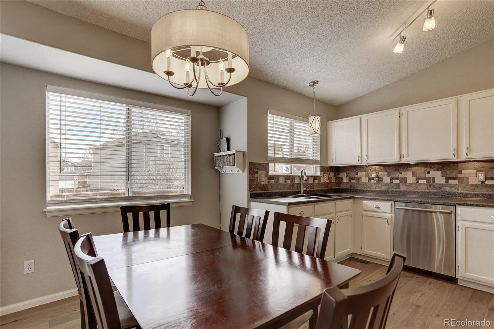 10626 Hyacinth Court Highlands Ranch, CO 80129 - Photo 8 of 38 a view of a dining room with furniture window and wooden floor