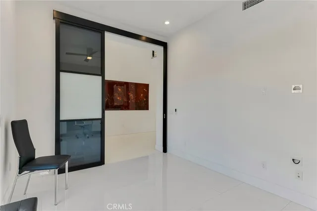 a large bed sitting in a room next to a window